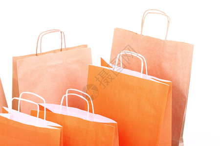 白色背景孤立的购物橙色礼品袋背景图片