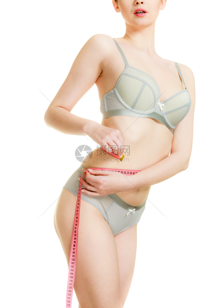 穿内衣的瘦女孩用测量胶带腰部女身体的一部分饮食减瘦体重的时间到了穿内衣的妇女用测量胶带腰部图片