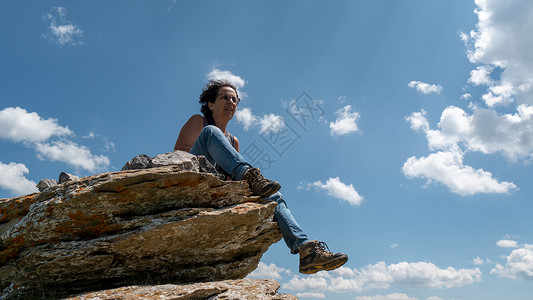 坐在云上嫦娥一位坐在岩石上登山的女人背景