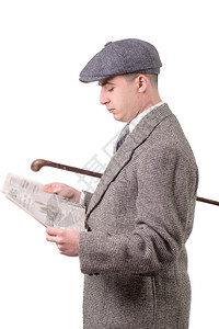 穿着戴帽子的旧衣服青年男子阅读报纸白色1940年风格图片