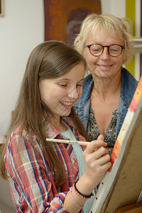 和老师一起画画的年轻少女图片