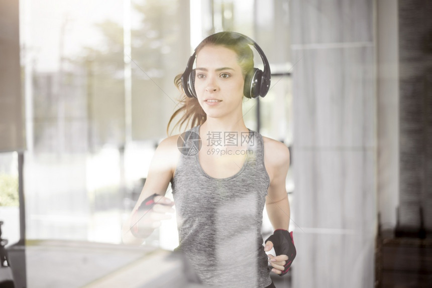 漂亮的年轻运动女子正在健身运动场跑步健康生活方式图片