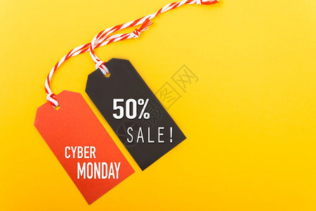 网上购物推广网络星期一销售的红色标签和50销售的黄色背景黑标签背景图片