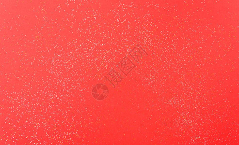 红色背景的闪光颗粒点圣诞节装饰带有复制空间图片
