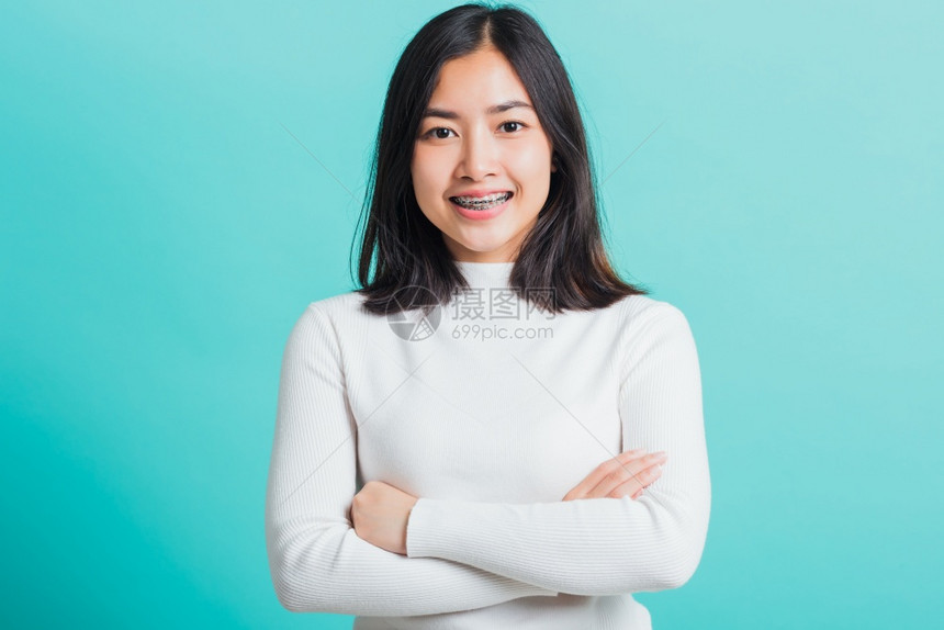 年轻美丽的亚洲女微笑着横穿双臂正面自信的女站在肩膀交叉图片