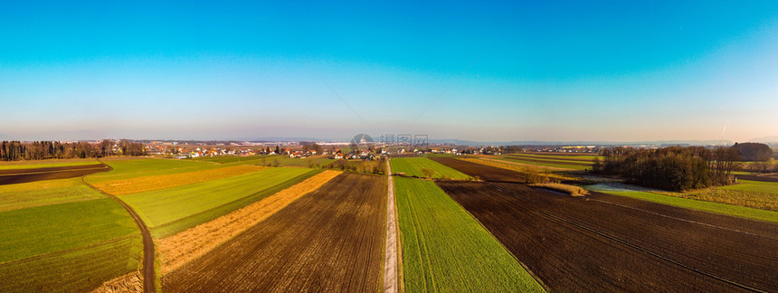 在奥地利施蒂里亚Styria阳光明媚的冬季日落乡村空中全景在美丽的自然景观中有太阳蓝天和绿地的路线背景在奥地利施蒂里亚Styri图片