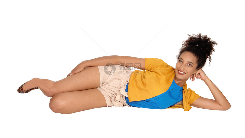 一个美丽的多种族妇女躺在地板上穿着黄色毛衣和米花短裤图片