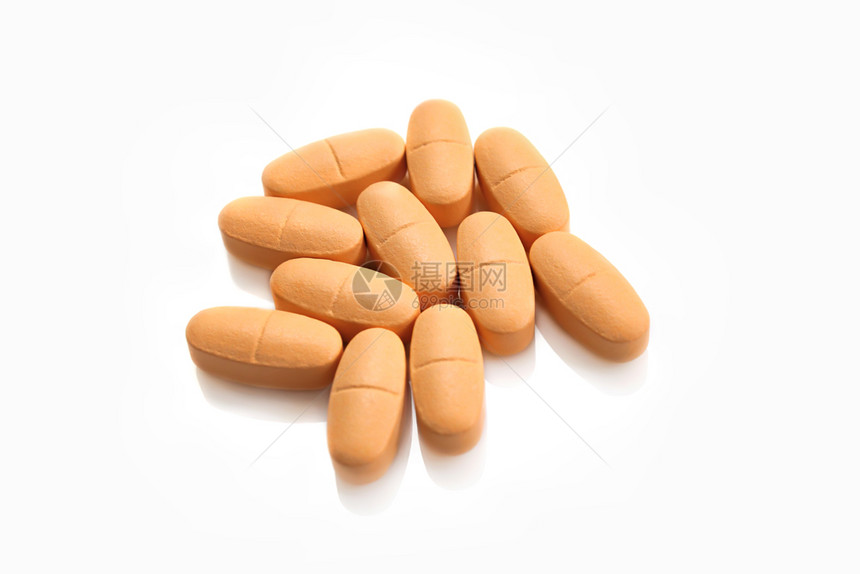 大量橙色药丸在白背景上被孤立图片