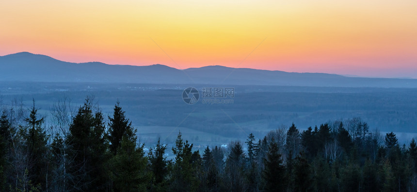 春夕日落山地前与森林田野村庄的乡观望图片