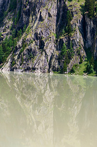 夏季阿尔卑斯山地景观包括动荡的储水池湖和陡峭的岩坡瑞士图片