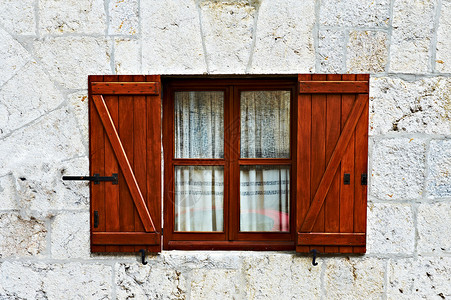 西班牙一栋石屋的外墙上有开着百叶窗的木质户图片