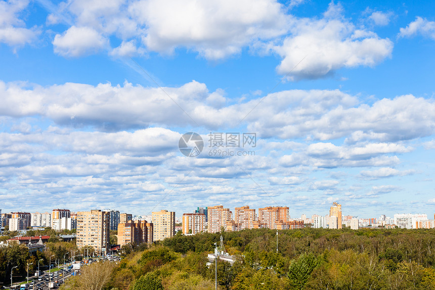 在阳光明媚的秋天在街道和城市公园的蓝色天空中白云图片