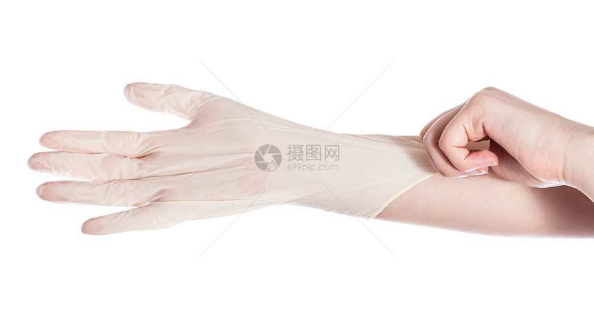 女手的顶部视图将乳胶手套戴在另一只上白色背景隔开图片