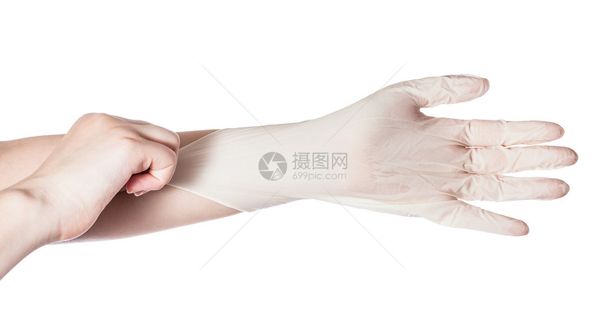 女手的顶部视图将乳胶手套拉到另一只在白色背景上隔离的手图片