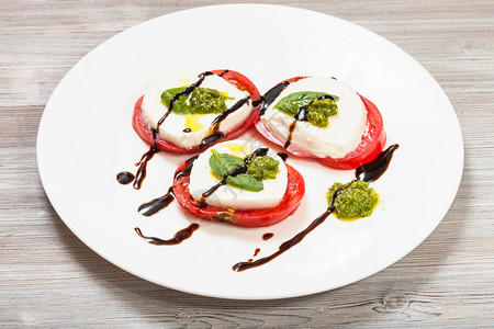 意大利菜烹饪Insalatacapresecapresesalase切片莫扎里拉奶酪番茄含橄榄油的basil叶子白醋和木制桌上板背景