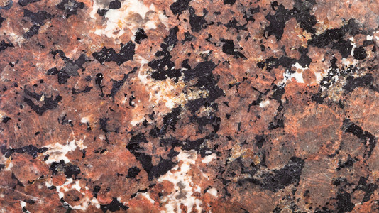 抛光天然Urtite岩靠近的表面天然Urtite岩的全光背景图片