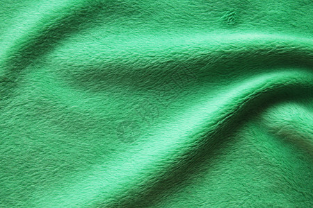 质地深绿色粗织物的纹理和背景是卷状折叠谎言皱巴的背景图片