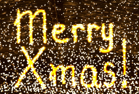 发光的闪亮字词灯光周围的圣诞快乐孩子们画英语希望背景图片
