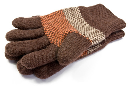 冬天针织的蓬松白色背景温暖羊毛编织手套图片