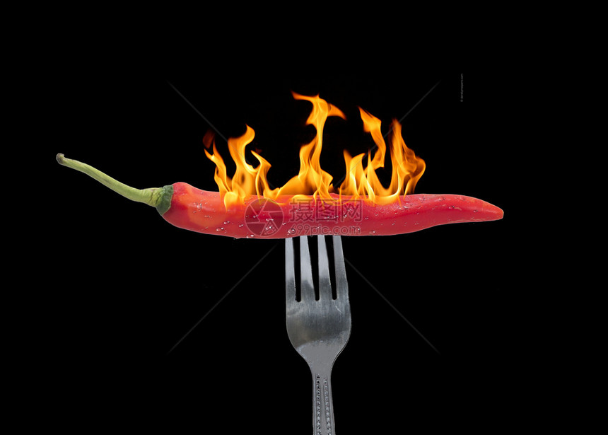 晚餐一种吃红辣椒是用火和食物概念刺穿叉子的红辣椒图片