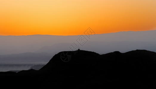 以色列的阿拉瓦沙漠在日出前数分钟发生薄雾无水天空背景图片