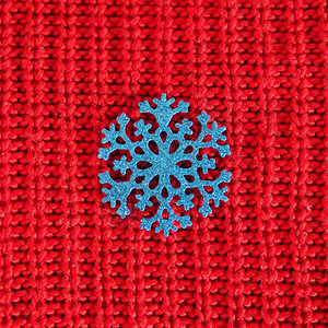 闪光红色的编织背景蓝闪亮雪花毛衣图片
