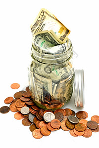 由纸币和硬组成的玻璃罐中小型储蓄账户一个小储蓄账户节省巢富有的图片