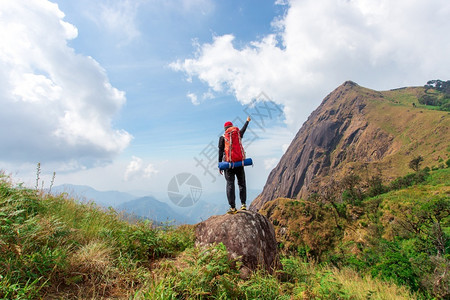 伸手触碰天空的登山者背景图片
