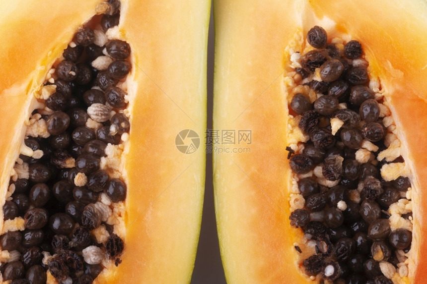 热带橙木瓜将近距减半背景图像种子图片