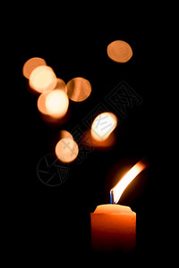 夜晚烛光点燃蜡黑暗背景上布OKH和平黑色的橙图片
