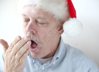打哈欠圣诞老人假期年男子因圣诞节活动而疲倦背景图片