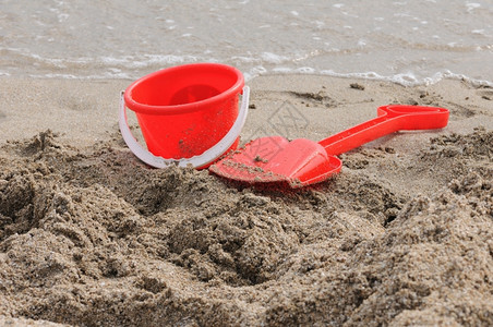 塑料一种沙滩上的红桶和铁锹水图片