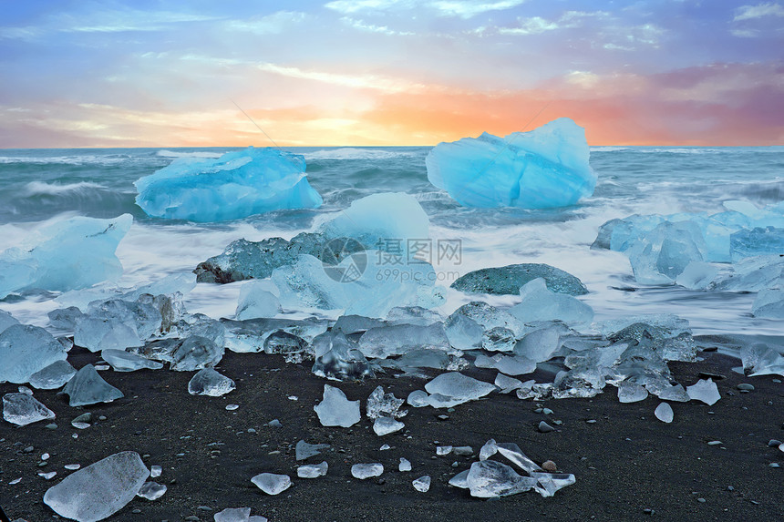 约古沙龙冰岛Jokulsarlon黑沙滩上的冰石暮日落图片