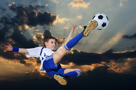 落下男人冠军足球运动员在阴云的天空背景下图片