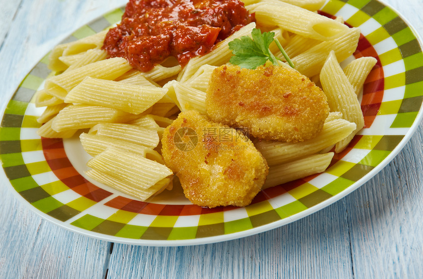 晚餐午意大利语菜面和番茄酱的Nuggeets图片
