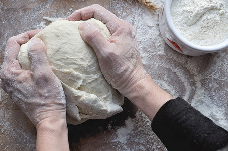 木板上的厨师准备面包皮经过手糕点背景图片
