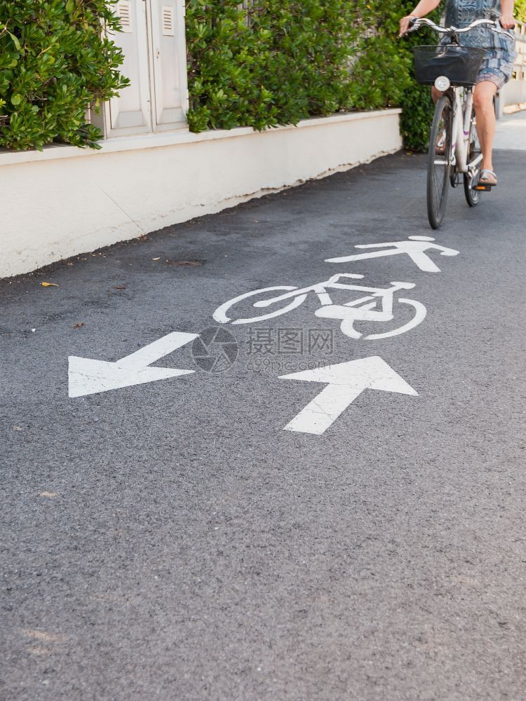 街道女纳达林自行车路标和箭头A自行车道图片