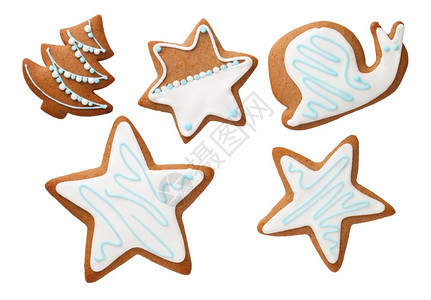 生姜甜点圣诞饼以恒星圣诞树和蜗牛的形状在白色背景曲奇饼干上隔绝多于图片