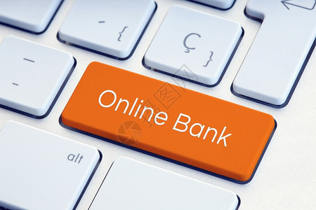 数字的银行业橙色键盘上的在线银行技术背景图片