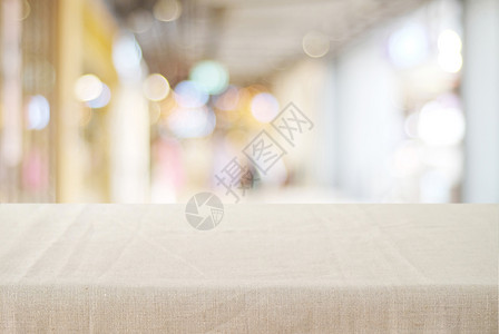 空桌布在基背景的模糊商店上铺有麻布桌产品显示齐装广告架子空白的图片