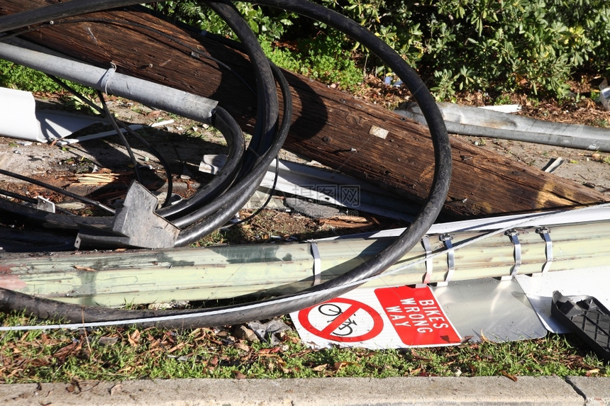 电压发生一辆车事故后损坏的公用设备和自行车标志已坠落碎片一种图片