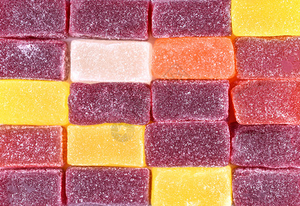 明胶洒甜点果酱糖背景冻特写五颜六色的糖果冻立方体撒上糖果酱背景图片