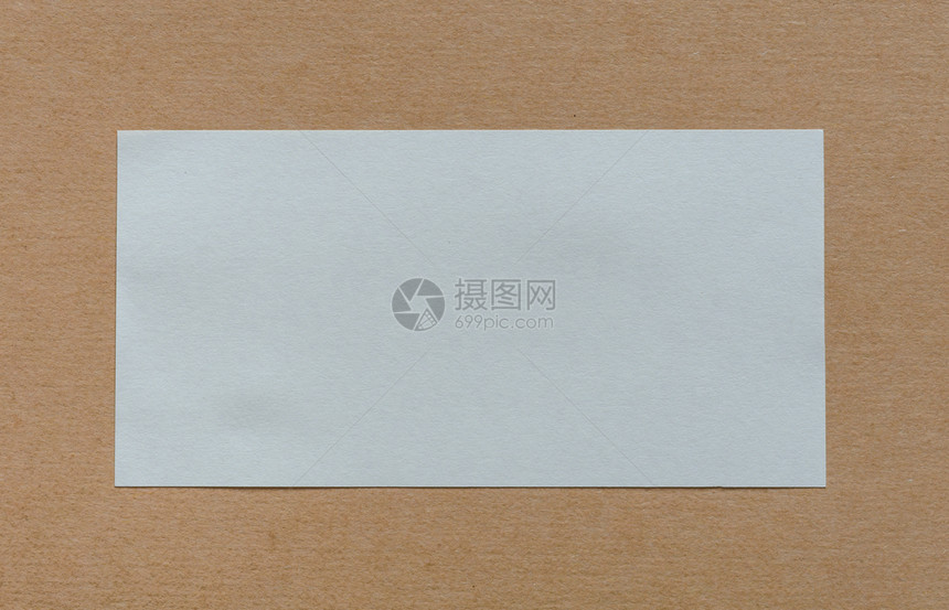 棕色卡士布背景上的空白纸贴标签包装空的横幅图片
