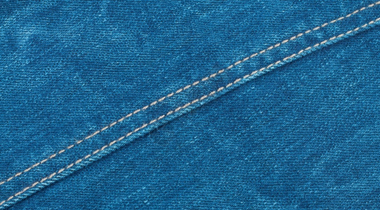 纺织品Denim背景带对角缝合穿过它一种通用的背景图片