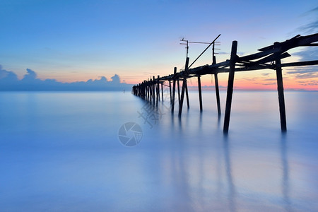 水景观古老的木桥在海中与日落木头图片