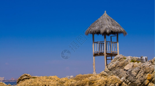 站在岩石海滩附近的木头守望塔海岸洋靠近图片