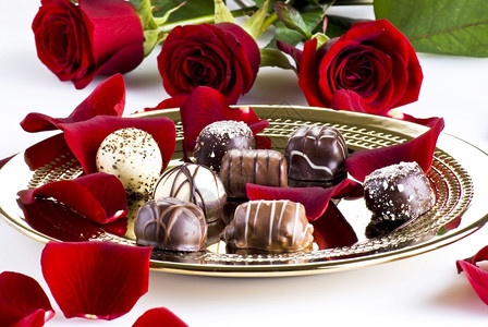 礼物金色的奢华巧克力盘加红玫瑰花瓣金子图片
