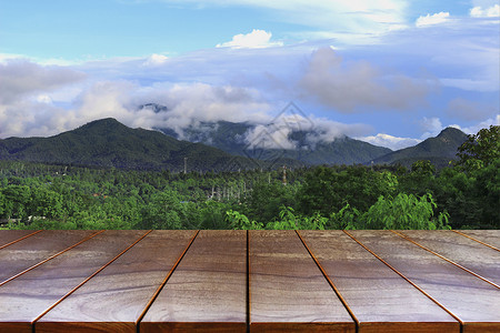剪辑风景素材剪辑地板空木制桌间平台和产品显示蒙戴的山地和天空背景产品布置的木板表格景观背景