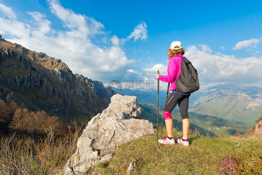 孤独走女孩远足者在山上散步时停留在山上看风景身体的图片