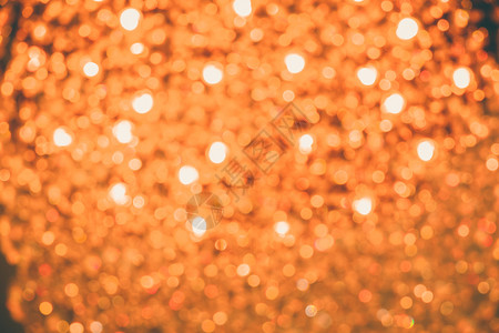 圆圈用于背景图像的金橙色光线上Bokeh抽象的颜色图片
